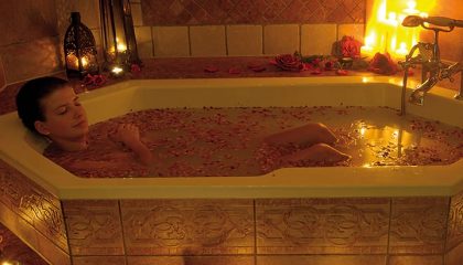 Frau nimmt ein Bad im Kerzenlicht