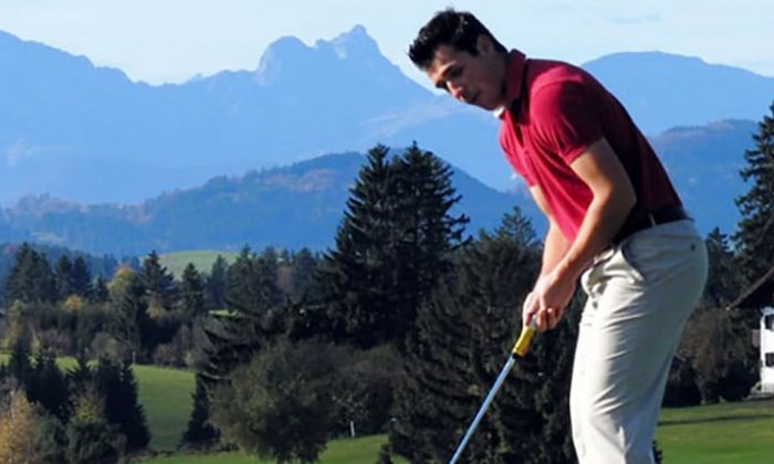 Mann spielt Golf in den Alpen