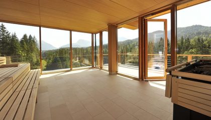 Sauna mit großer Glasfassade und Blick auf umliegenden Wald