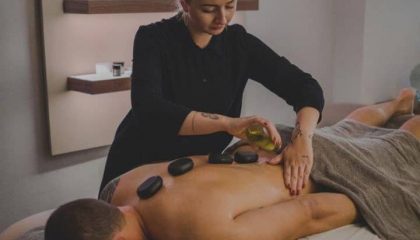 Mann genießt eine Hot Stone Massage