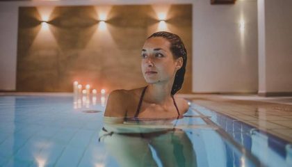 Frau kühlt sich im Pool ab