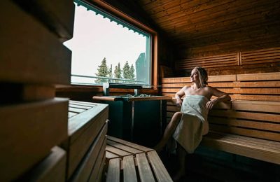 Frau genießt einen Saunagang mit Blockhaussauna