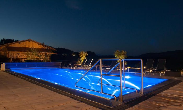 Beleuchteter Außenpool bei Nacht