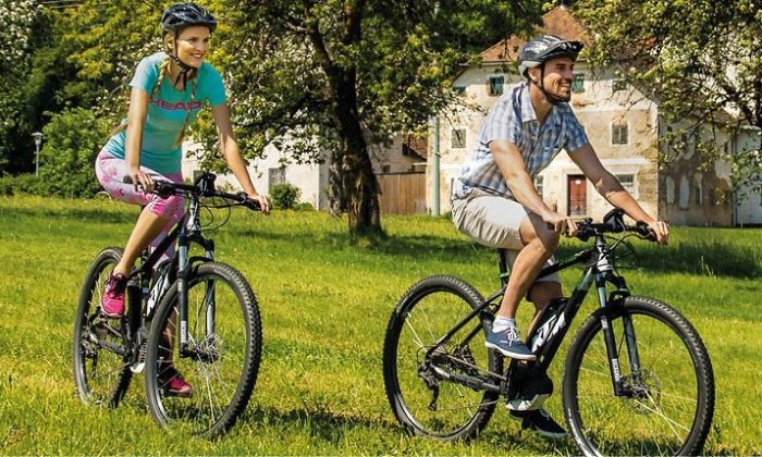 Mann und Frau fährt auf Mountainbikes durch die Natur